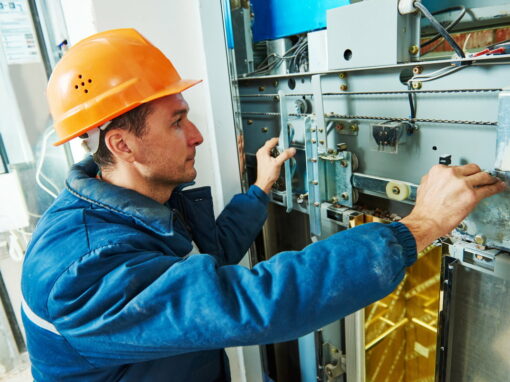 An elevator technician inspecting components